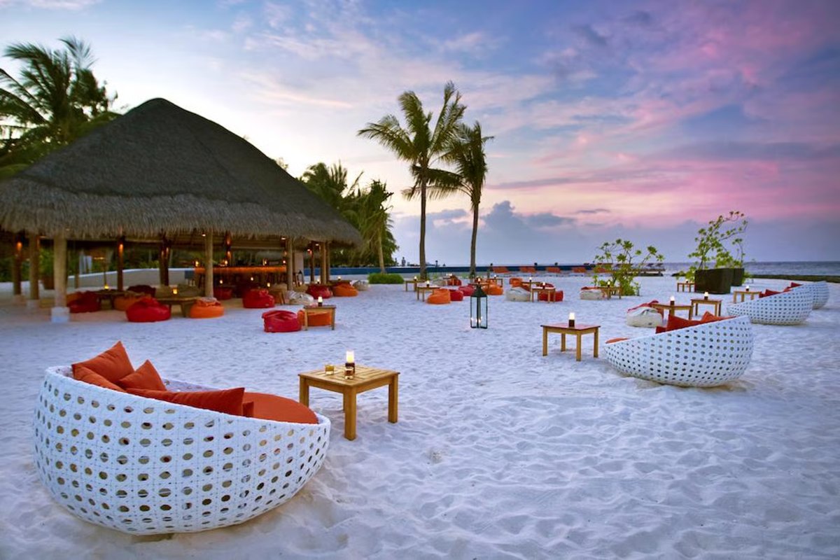 Sunset beach lounge area at a Maldives resort